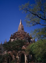 MYANMAR, Bagan, Shwegugyi Pahto or Great Golden Cave in old city.  Exterior framed by trees showing