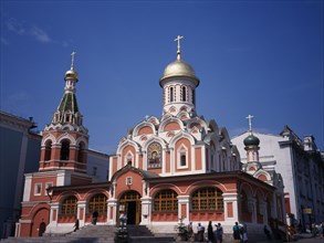 RUSSIA, Moscow, "Exterior of refurbished church with red and white painted facade, gold domed roof