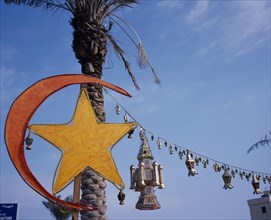KUWAIT, Kuwait City, Gulf Road.  Crescent moon and lantern decorations for Eid at the end of