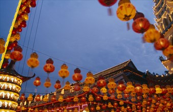 MALAYSIA, Penang, Kek Lok Si Temple, Temple roof decorated with lights and hung with red and yellow