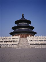 CHINA, Beijing, Temple of Heaven.  Hall of Prayer for Good Harvests with western tourist standing