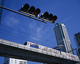 THAILAND, Bangkok, "Looking up at skytrain, traffic lights and high rise commercial building."