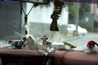 VENEZUELA, Caracas , "Dashboard of Caracas taxi including religious artefacts, a comb and reading