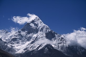 NEPAL, Himalayas, Khumbu Region, Mount Ama Dablam.  Snow covered peak of west face in drifting