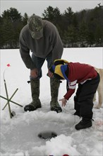 USA, New Hampshire, Marlborough , "Father and Son,Mike Stone and Tyler Stone ice fishing