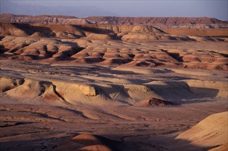 MOROCCO, Ait Benhaddou, Wind eroded desert landscape.