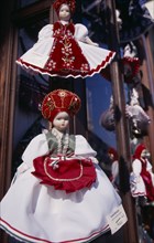 HUNGARY, Budapest, Handmade dolls in National costume for sale displayed outside shop window.