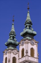 HUNGARY, Budapest, Church of St Anne in Batthyany Square.  Detail of twin clock towers with copper