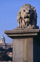 HUNGARY, Budapest, Stone statue of lion on Chain Bridge. Eastern Europe