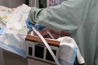 CHILDREN, Babies, Birth, Nurse taking newborn baby measurements in hospital