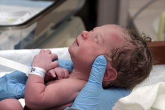 CHILDREN, Babies, Birth, "Kylan Stone, newborn baby girl being checked by nurse in hospital."