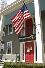 USA, New Hampshire, Hancock, Hancock Inn with large US stars & Stripes flag flying.