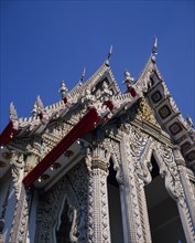 THAILAND, Bangkok, Sathorn District, Charoen Krung.  Highly decorated temple rooftop on Chao Phraya