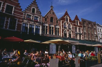 BELGIUM, West Flanders, Bruges, The Markt (Market Place)  Line of cafes with busy outside tables