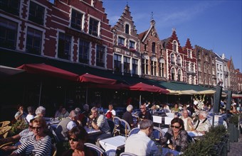 BELGIUM, West Flanders, Bruges, The Markt (Market Place) Line of cafes with busy outside tables