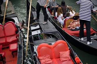 ITALY, Veneto, Venice, Gondolas with tourists passing each other closely in the narrow canals in