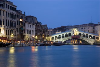 ITALY, Veneto, Venice, The Rialto Bridge on the Grand Canal illuminated at night
