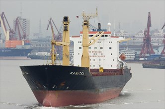 CHINA, Jiangsu, Shanghai, Freighter sailing from Shanghai along Huangpu River