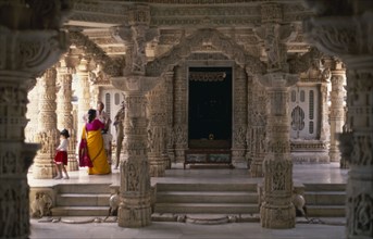 INDIA, Rajasthan, Mount Abu, Dilwara Temples.  Vimal Vasahi 1031 A.D. Visitors on raised platform