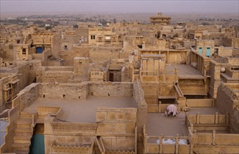 INDIA, Rajasthan, Jaisalmer, View over flat roof houses of desert town.
