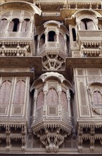 INDIA, Rajasthan, Jaisalmer, Detail of intricately carved facade of sandstone merchant’s house or