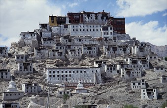 INDIA, Ladakh, Tikse Gompa, Tibetan Buddhist monastery and surrounding buildings set into steep
