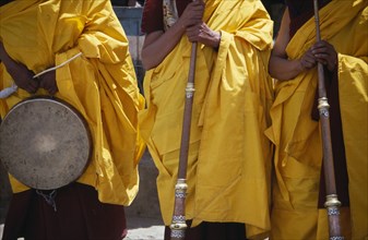 INDIA, Ladakh, Hemis Gompa, Tibetan Buddhist lamas in ceremonial yellow dress with traditional
