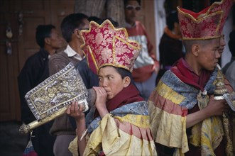 INDIA, Ladakh, Music, Young Tibetan Buddhist lamas playing the Shankh or conch shell.
