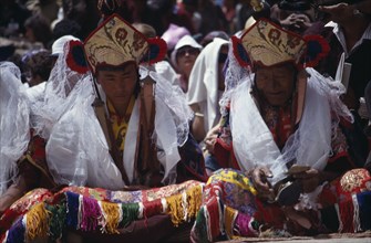 INDIA, Ladakh, Hemis Gompa, "Lamas wearing kartas receiving offerings from pilgrims during Hemis