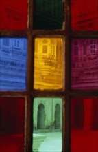 INDIA, Rajasthan, Jodhpur, Jodhpur fort seen through coloured rectangles of stained glass door.