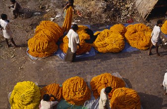 INDIA, West Bengal, Calcutta, "Looking down on marigold sellers.  Marigolds are sold by weight or