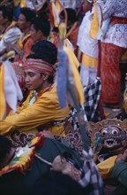 INDONESIA, Bali, Religion, Young man amongst crowd during festival celebrations.