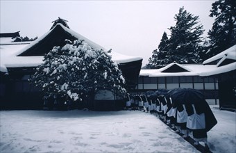 JAPAN, Honshu, Kii Peninsula, Mount Koya-san.  Venerated Shingon-Buddhist site.  Line of monks