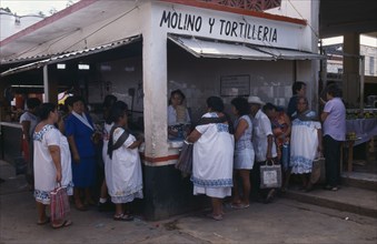 MEXICO, Yucatan, Ticul, Men and women queuing at the tortilleria.