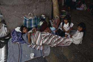 MEXICO, Mexico State, Chalma, Young woman and children on pilgrimage to Chalma resting on roadside