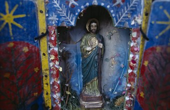 ECUADOR, Religion, Icon, Religious statuette in blue painted shrine with feathers in coloured paper