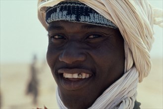 MAURITIUS, Portraits, Men, Mauretanian man smiling to show gold front tooth.