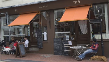 ENGLAND, East Sussex, Brighton, Nia restaurant in Trafalgar street with people sat outside.