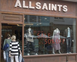 ENGLAND, East Sussex, Brighton, Shoppers entering the All Saints shop in Dukes street. 50% sale
