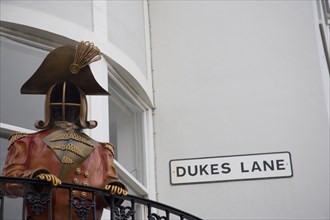 ENGLAND, East Sussex, Brighton, Metal sculpture above the entrance to the Duke Lane Shopping area.