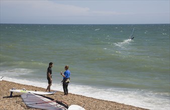 ENGLAND, East Sussex, Brighton, Windsurfers on the beach at Hove.