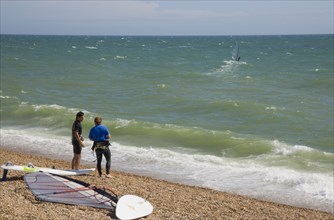 ENGLAND, East Sussex, Brighton, Windsurfers on the beach at Hove.