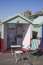 ENGLAND, East Sussex, Brighton, Colourful beach hut interior on the seafront at Hove lawns.
