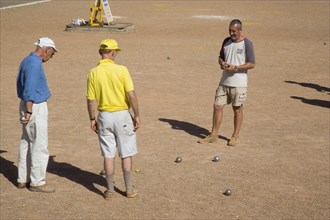 ENGLAND, East Sussex, Brighton, People playing petanque on the seafront.