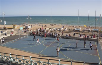 ENGLAND, East Sussex, Brighton, Basketball court on the seafront.