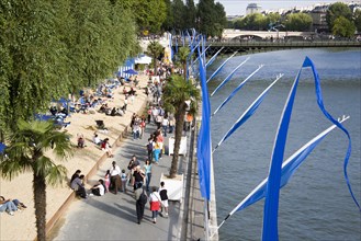 FRANCE, Ile de France, Paris, The Paris Plage urban beach. People strolling between the River Seine