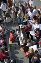 FRANCE, Ile de France, Paris, The Paris Plage urban beach. A singer playing a piano to an audience
