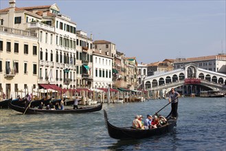 ITALY, Veneto, Venice, A Traghetto with local people on board crosses the Grand Canal and a Gondola