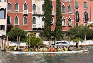 ITALY, Veneto, Venice, Local schoolchildren rowing a dragon boat on the Grand Canal