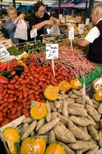ITALY, Veneto, Venice, Fruit and vegetable stall in the Rialto market with shoppers and vendors
